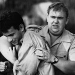 CIRCA 1984: Tom Hanks is grabbed by John Candy in a scene for the TriStar Pictures movie 'Volunteers' circa 1984. (Photo by Hulton Archive/Getty Images)