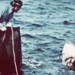 American actor Richard Dreyfuss (left) (as marine biologist Hooper) and British author and actor Robert Shaw (as shark fisherman Quint) look off the stern of Quint's fishing boat the 'Orca' at the terrifying approach of the mechanical giant shark dubbed 'Bruce' in a scene from the film 'Jaws' directed by Steven Spielberg, 1975. The movie, also starring Roy Scheider and Lorraine Gary, was one of the first 'Summer Blockbuster' films. (Photo by Universal Pictures courtesy of Getty Images)