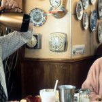 Bill Murray puts down a pitcher of coffee with Andie MacDowell in a scene from the film 'Groundhog Day', 1993. (Photo by Columbia Pictures/Getty Images)